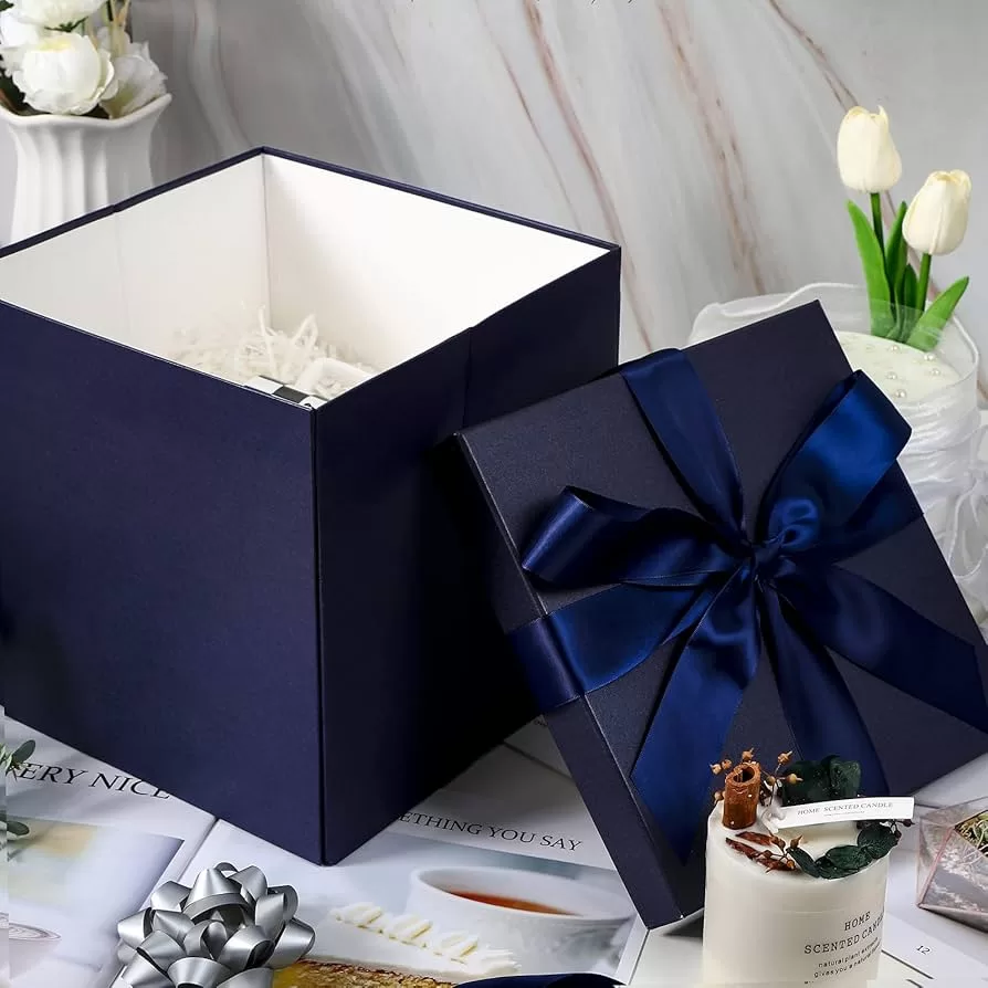 Navy blue perfume box with white interior and blue satin ribbon bow