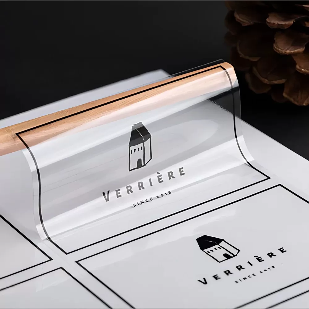 White custom sticker label with black logo and text on curved product packaging