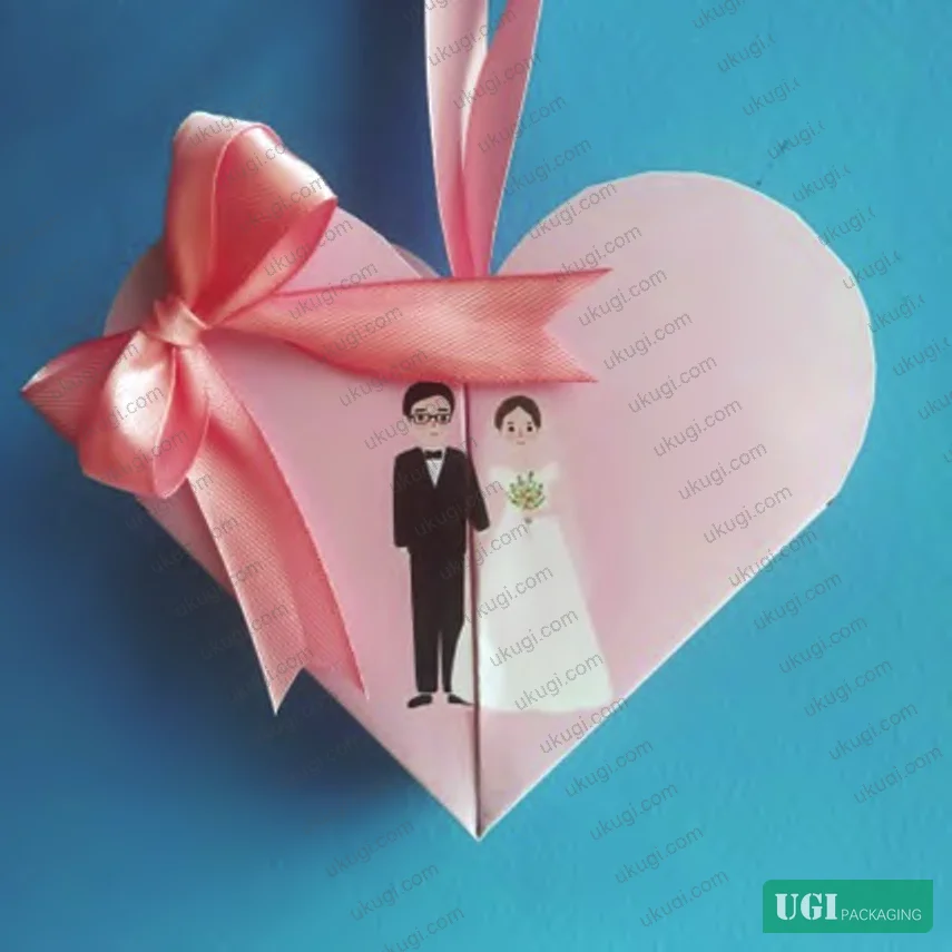 Figure 5: Prototype heart-shaped candy box with bow decoration, showing final assembled form and suspension display capability