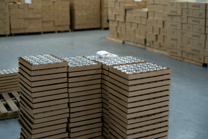 Multiple layers of glass bottles and cardboard trays prepared for transport