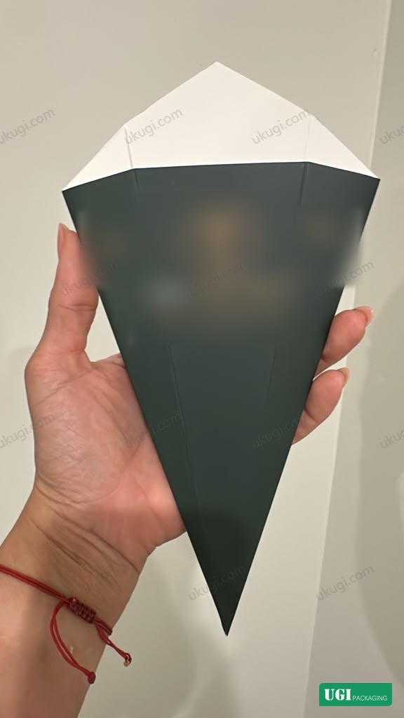 An anonymized folded triangular paper French fry cone reference with customer branding removed